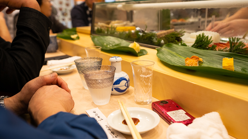 Eating best sushi with sake in Toyosu fish market